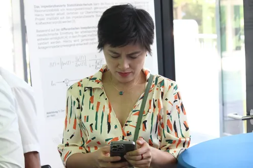 Teilnehmer einer Fachkonferenz sitzen in einem Hörsaal und verfolgen aufmerksam eine Diskussion.